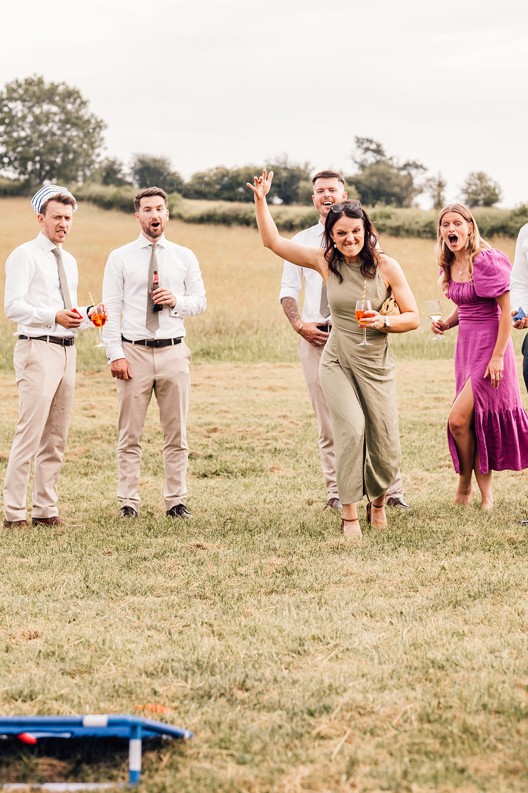 guests enjoy garden games at tipi wedding in yorkshire countryside